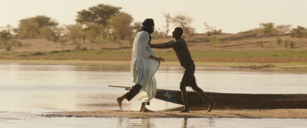 Kidane (Ibrahim Ahmed, left) the herdsman tussles with the fisherman Amadou who has killed one of his cows.