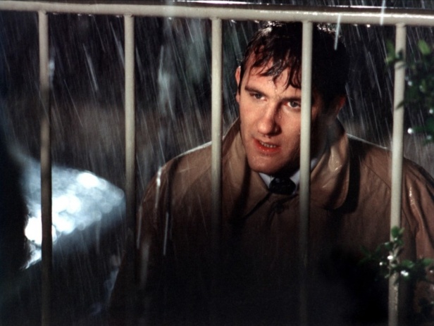 David caught in the rain and behind the front gate of Lise's house – the perfect image of a man trapped in his obsessive and doomed desire?